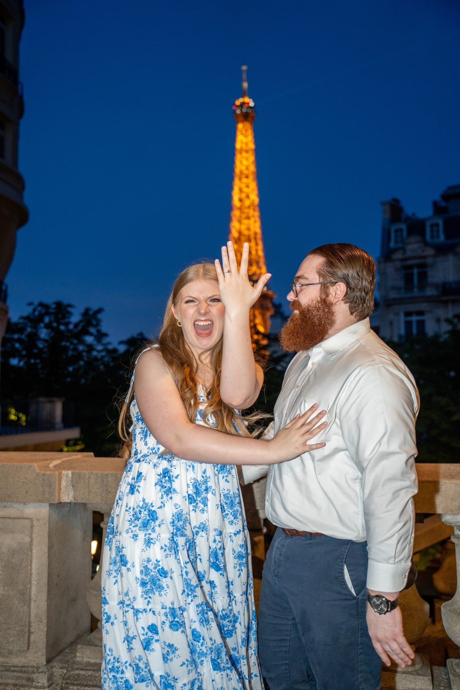 A surprise proposal photographed at night, on Avenue de Camoëns
