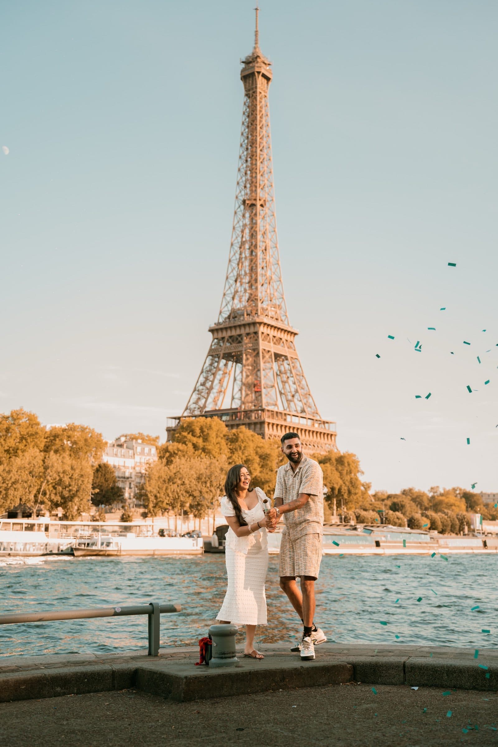 A couple photographed during a gender reveal, at the Eiffel Tower