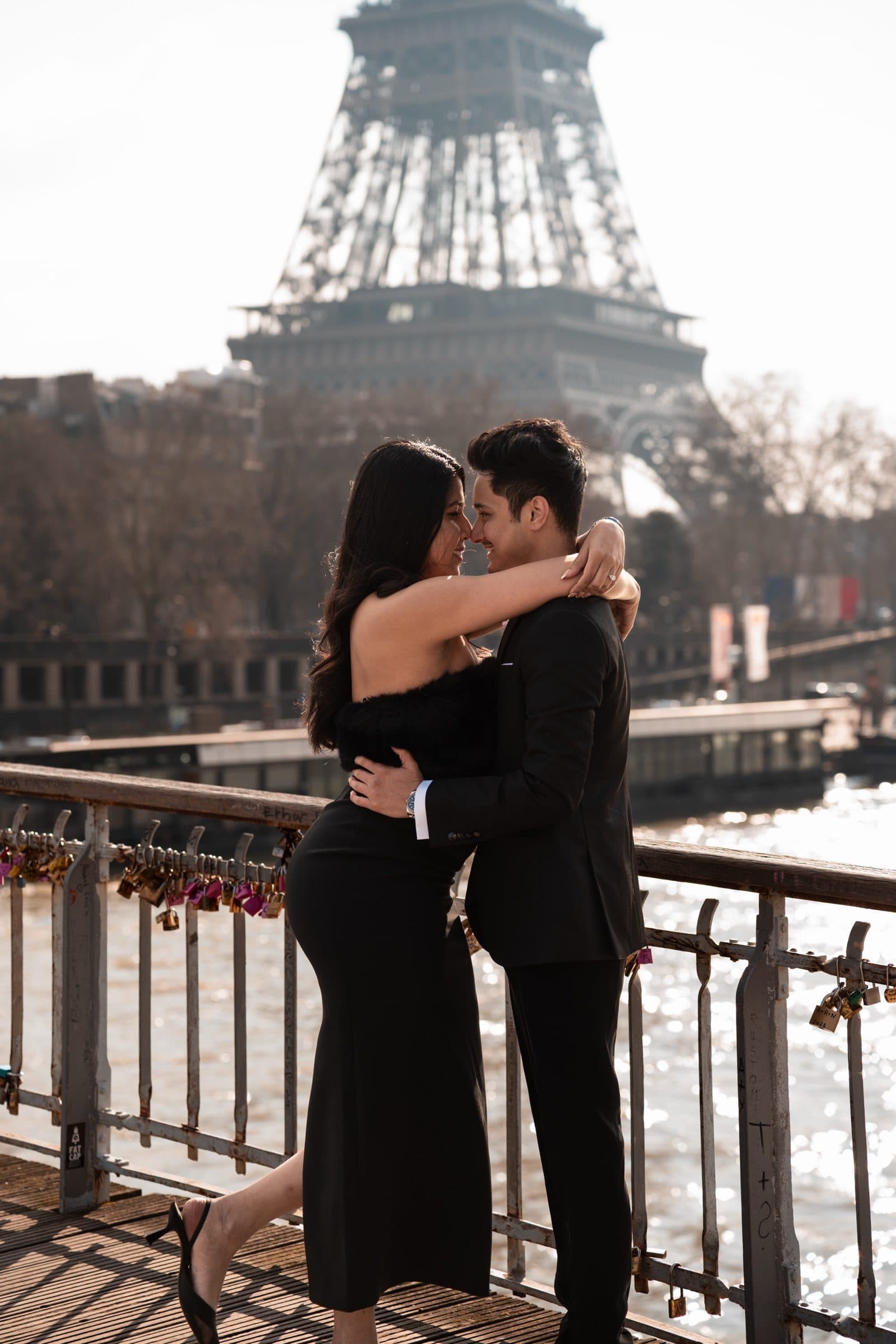 A couple photographed at golden hour, at the Eiffel Tower