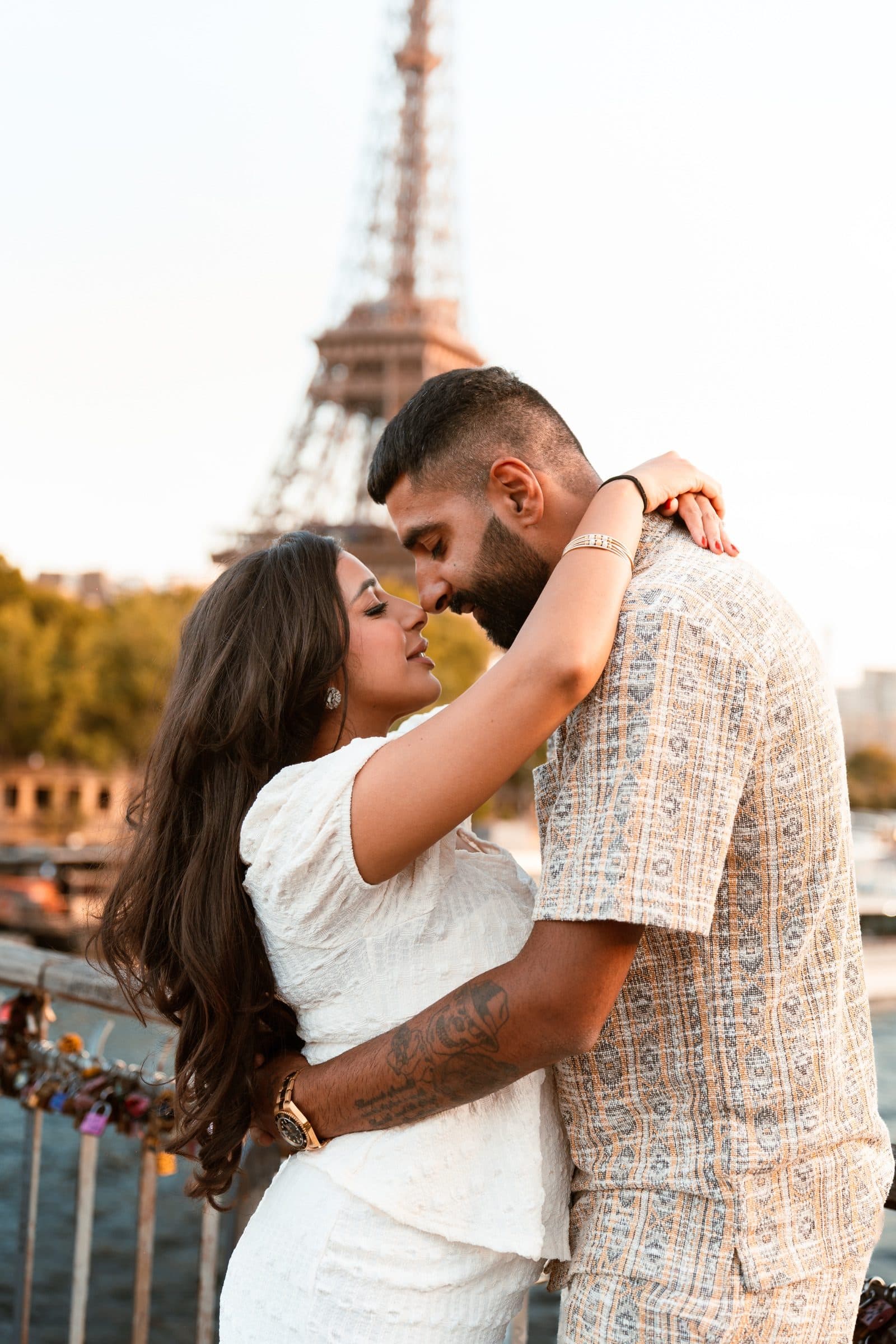A couple in portrait, at the Eiffel Tower