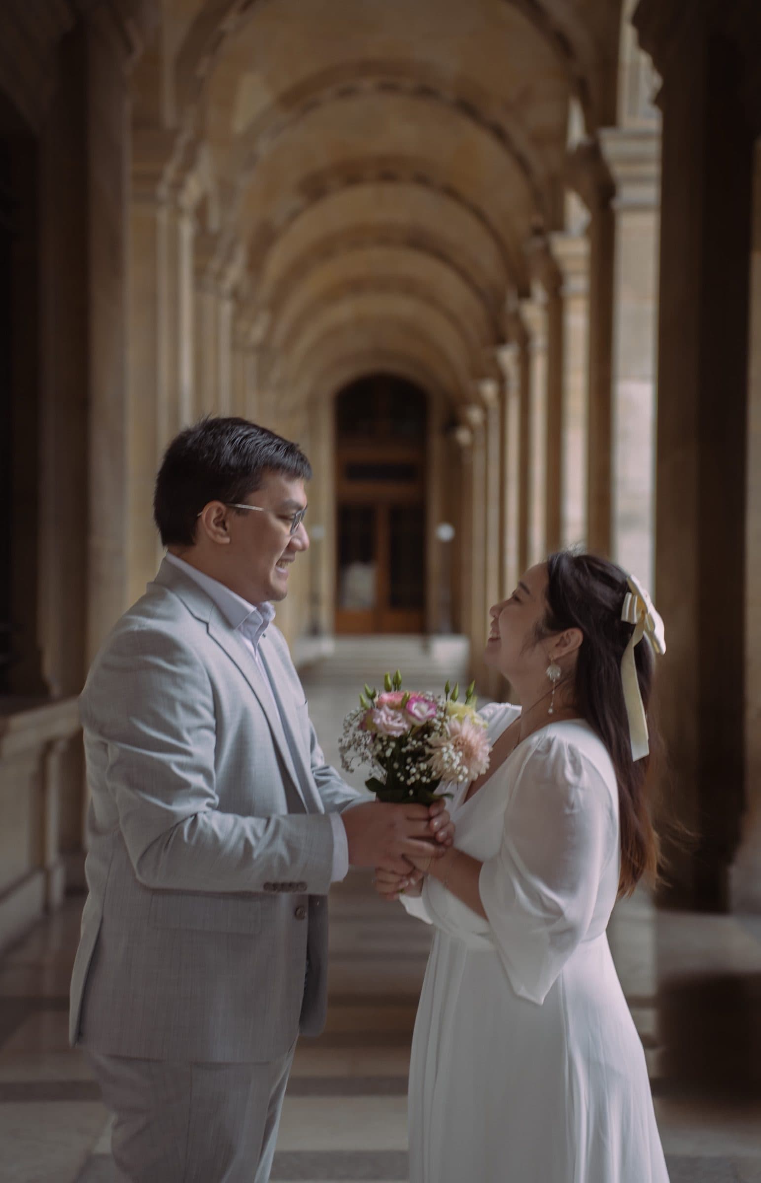 A couple in a pre-wedding portrait at the Louvre