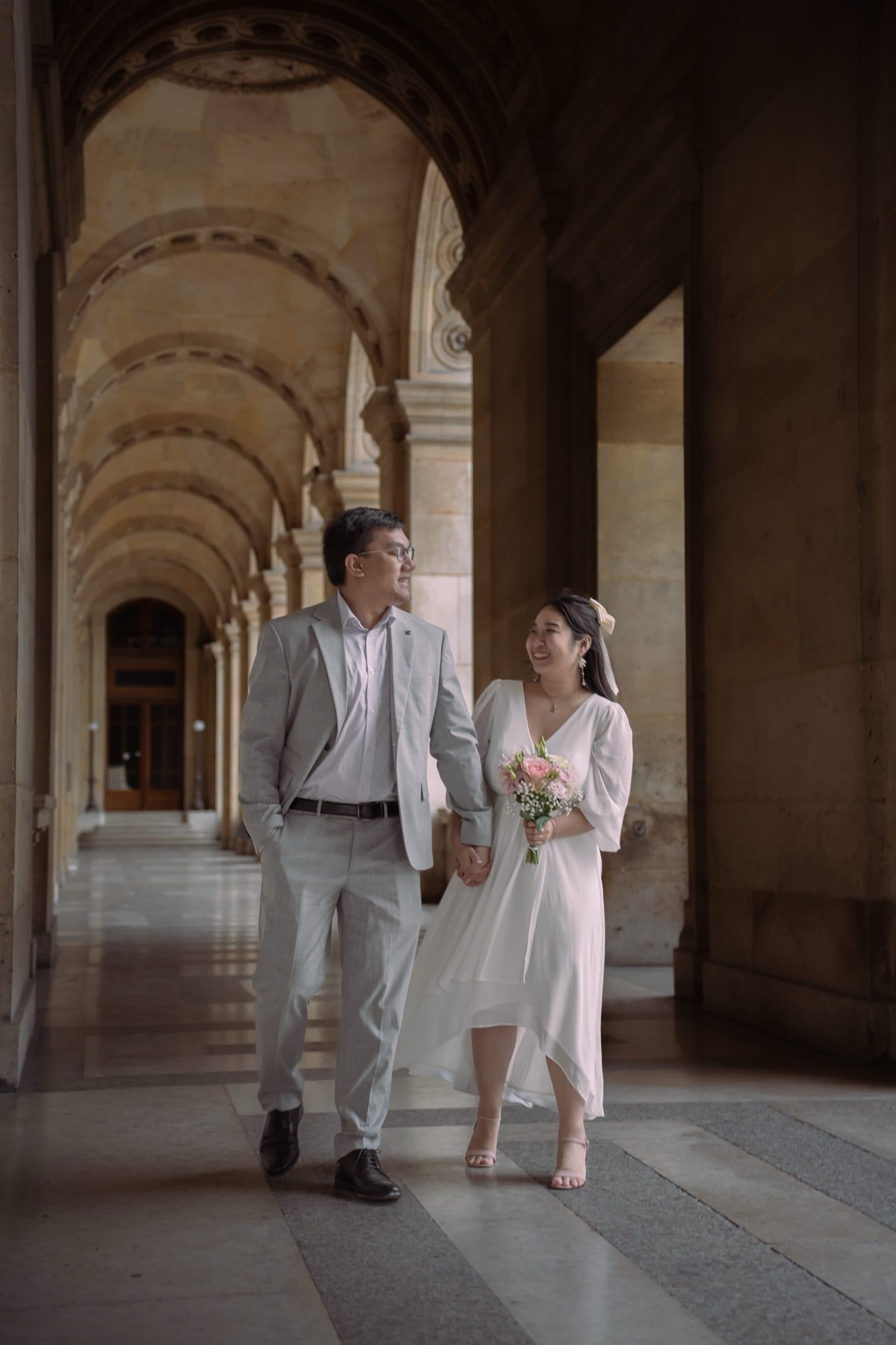 A couple in a pre-wedding portrait at the Louvre