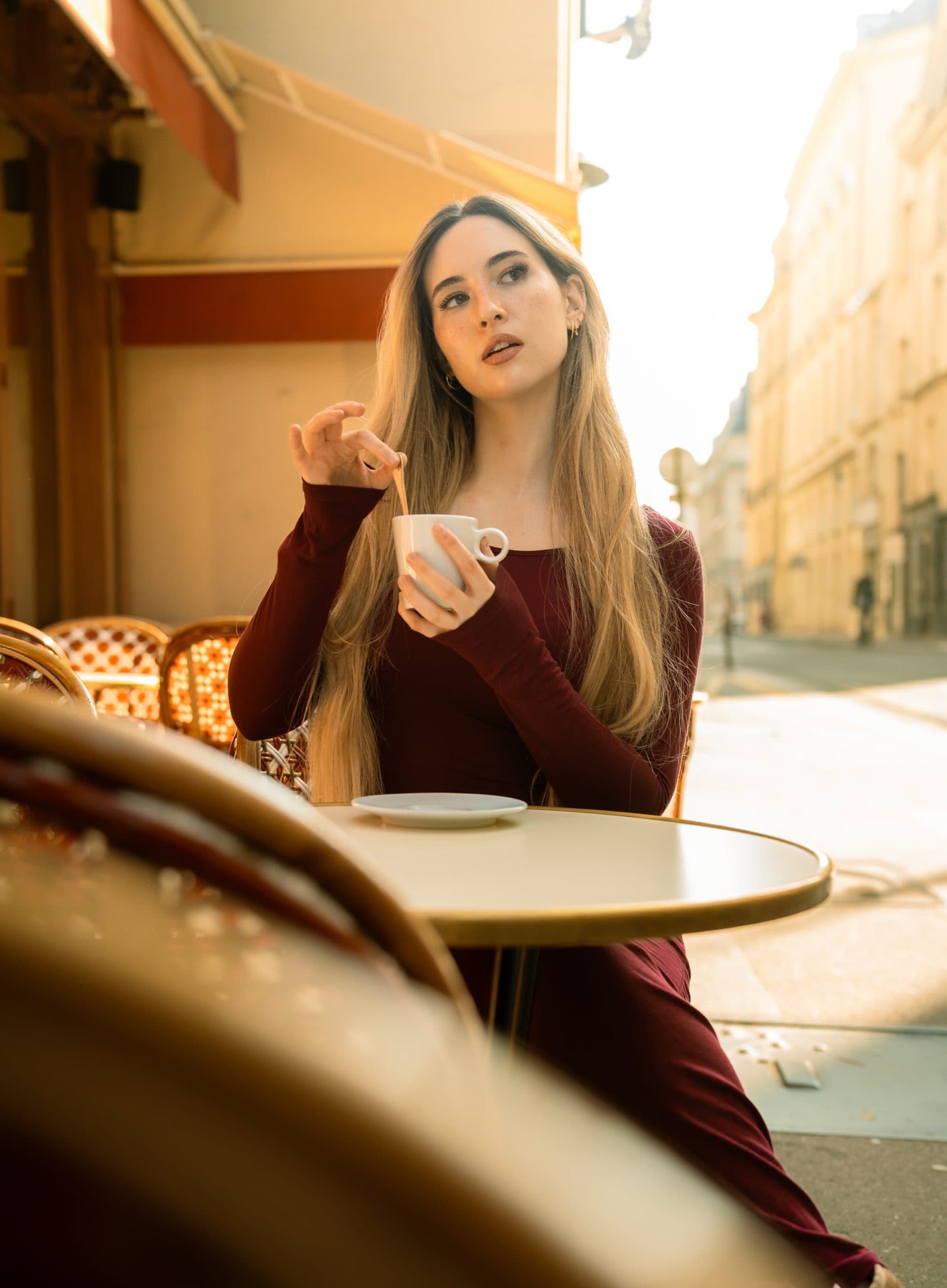 A solo traveller in portrait, in a Paris café