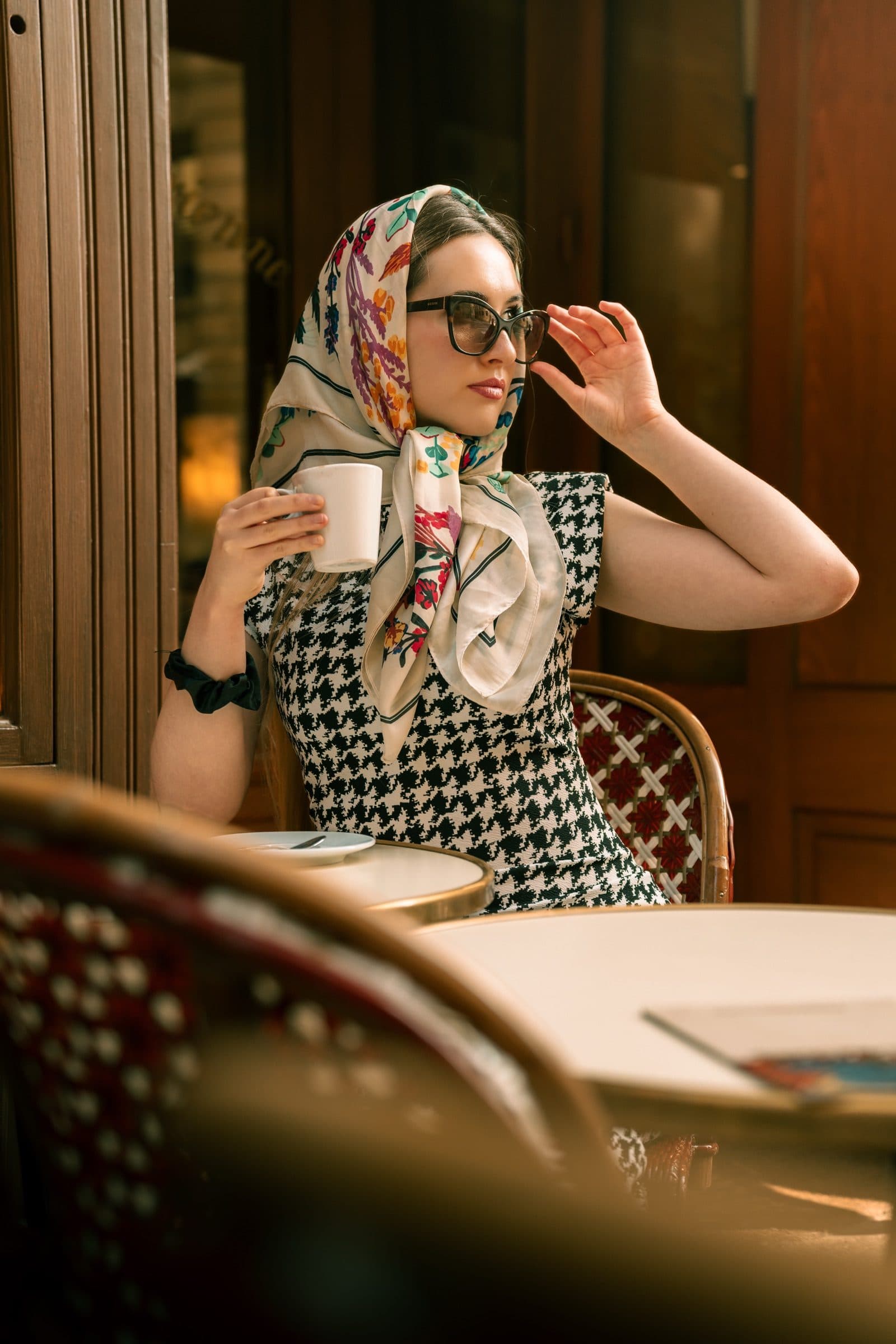 A solo traveller in portrait, in a Paris café