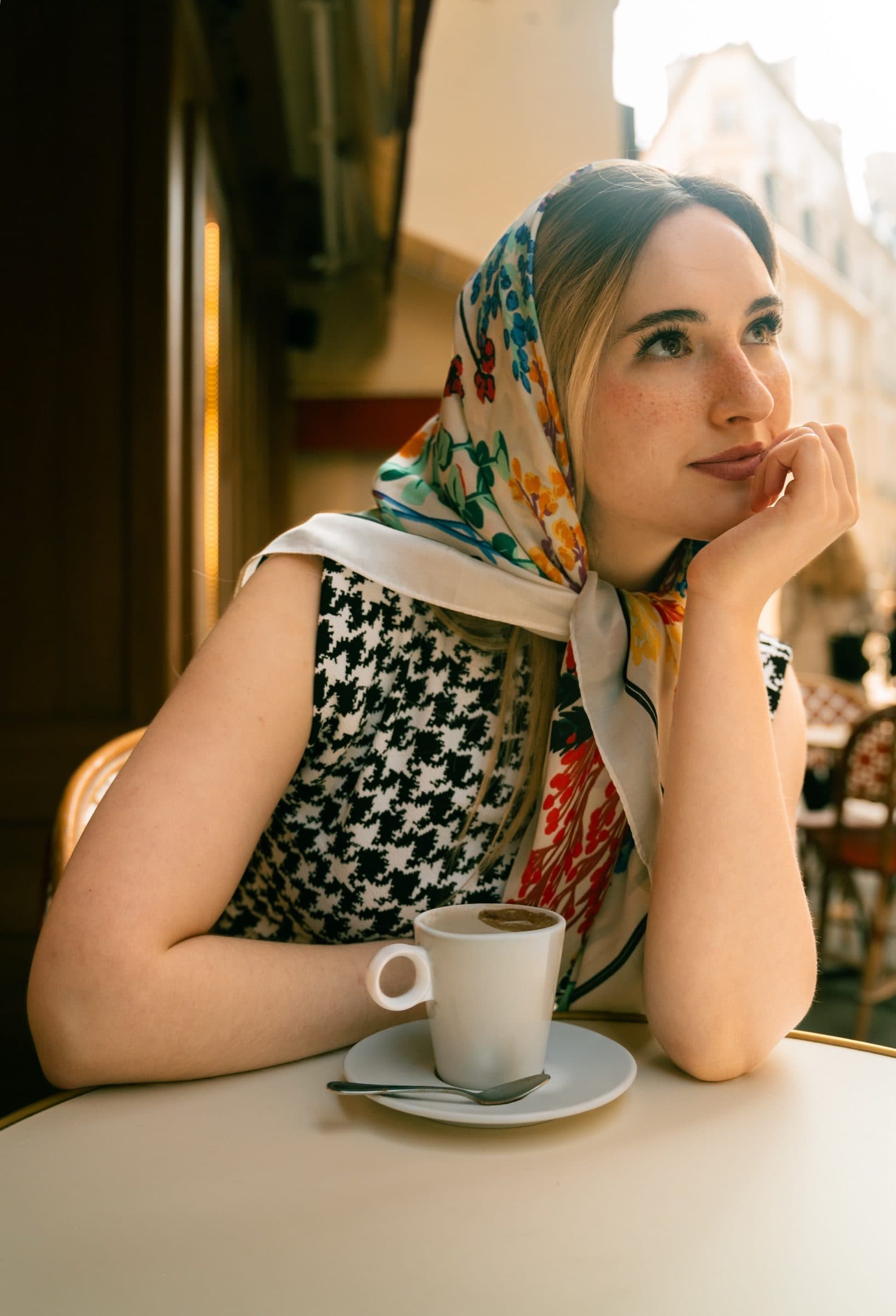 A solo traveller in portrait, in a Paris café