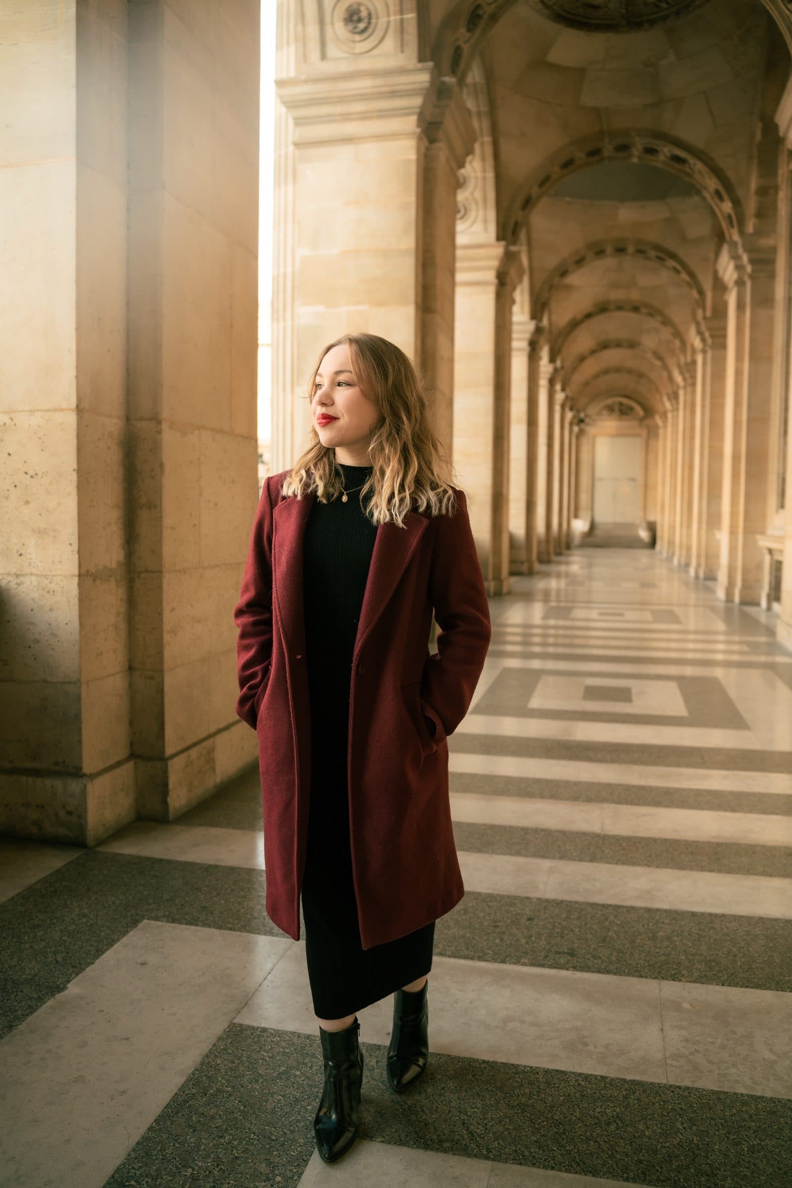 A solo traveller photographed at the Louvre at golden hour